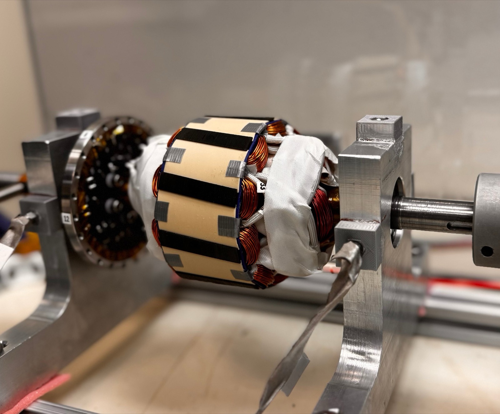 Prototype machine with copper-wound coils on a laboratory test fixture